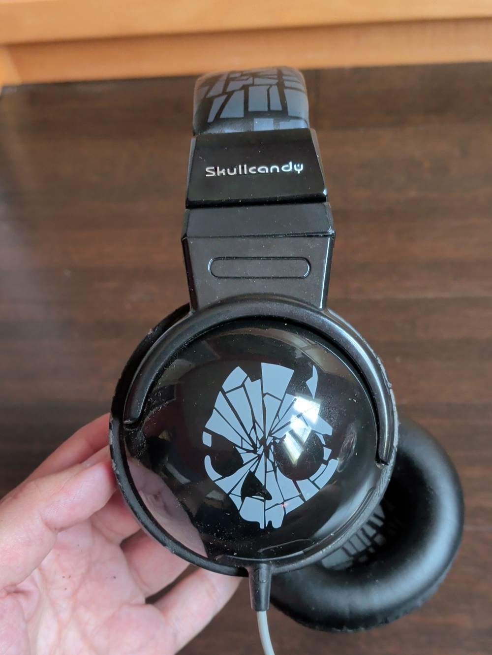 Skullcandy Black Headphones with Light Gray Shattered Skull Graphic